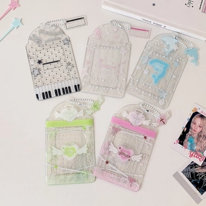 Detail of glitter star and dolphin cartoon card holders with white metal bead chains