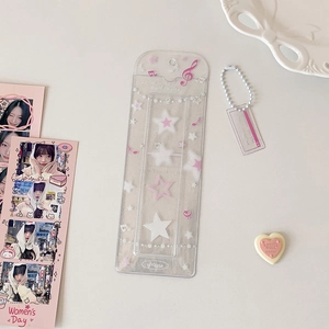 Close-up of glitter PVC card holder with pink star patterns and beaded chain pendant