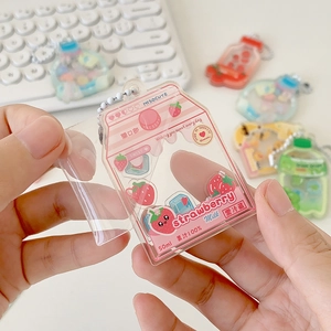 Cute acrylic strawberry milk carton shaker keychain with liquid charms and pink details