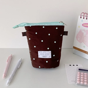 Brown telescopic pencil case with blue dots and cute tag on an aesthetic desk setup