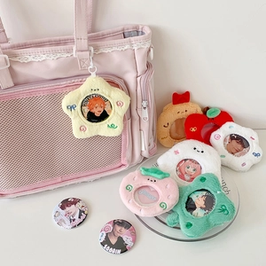 Plush star-shaped badge cover and round anime tinplate pin on a pink canvas bag