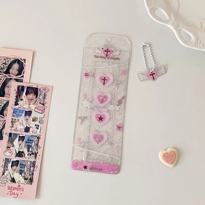 Close-up of glitter PVC photo sleeve with pink hearts and angel wing keychain charm