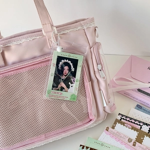 Detail of pink canvas bag with lace trim and transparent photocard holder keychain