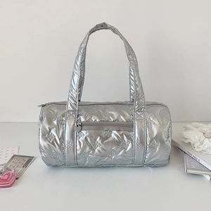 Detail of silver cylindrical bag with butterfly quilting and heart zipper pull