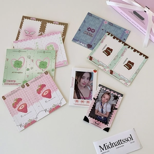 Flat lay of Korean style 3-inch photo card sleeves with cute clover and angel themes