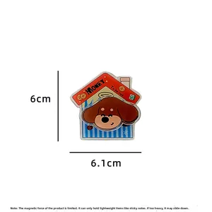 Detail of cartoon dog acrylic fridge magnet showing 6cm x 6.1cm size and magnetic clip feature