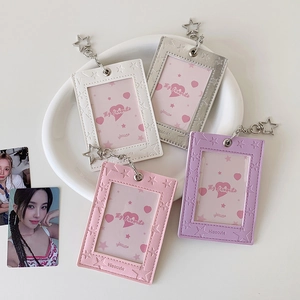 Close-up of star-embossed leather photo card holders in four pastel colors with star hooks