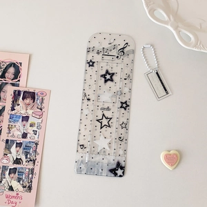 Close-up of music-themed transparent glitter photo holder with notes and star patterns