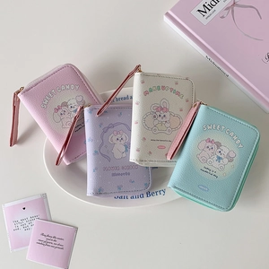 Four colorful cartoon mini wallets in a white dish with lanyard and metal zipper detail