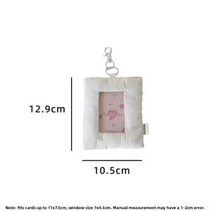 Close-up of beige fabric card holder with detailed dimensions and metal hook