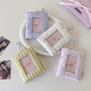 Detail of embroidered heart cutout card holders in pastel colors with metal clips