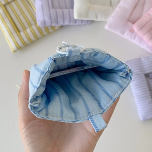 Blue striped heart embroidered plush card holder with open interior for cards and earphones