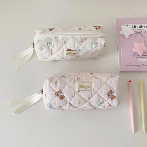 Detail of quilted cotton pencil case with cute bear floral pattern and ribbon zipper