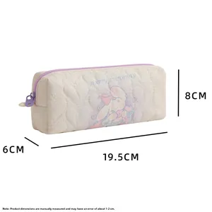 Detailed view of white quilted pencil case with cartoon print and purple zipper design