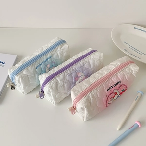 Detailed view of quilted pastel pencil cases with cute cartoon animals and heart stitching