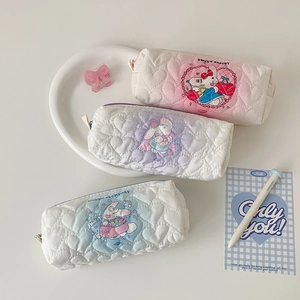 Close-up of heart-quilted pencil cases with cute cartoon rabbit and zipper closure