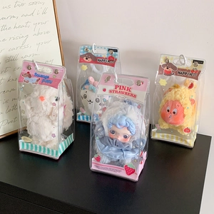 Close-up of four cute plush doll keychains in transparent gift boxes with handles