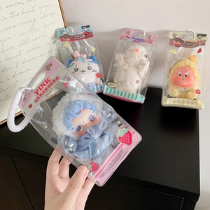 Detail of four cute plush charms in clear bags with white elastic hooks and decor cards