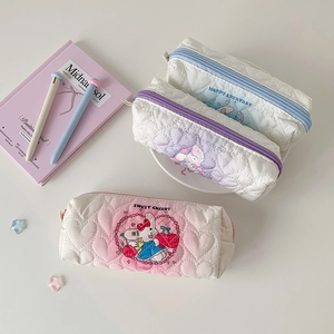 Detail of heart quilted pencil cases in pastel pink, purple and blue with cartoon art