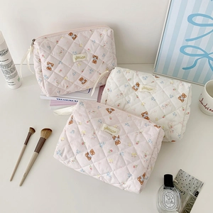 Quilted cotton cosmetic bag with bear floral pattern and ribbon zipper closure