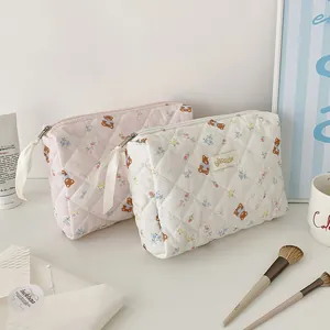 Detailed shot of quilted cotton cosmetic bags with cute bear and rabbit prints