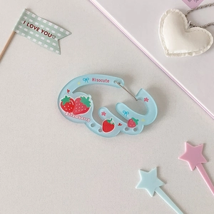 Detail of light blue acrylic wing carabiner with strawberry print and metal spring gate