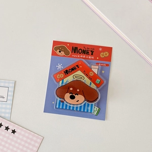 Close-up of cute acrylic cartoon puppy magnetic clip on aesthetic desk background