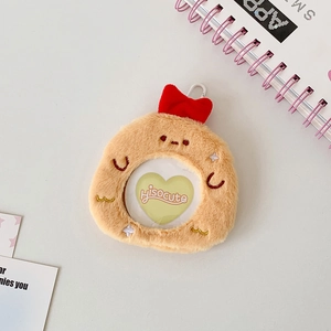 Close-up of plush cartoon badge holder with red bow and clear round window display