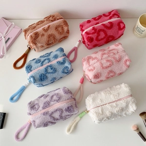 Large plush stationery pouches with colorful heart patterns and soft wrist straps