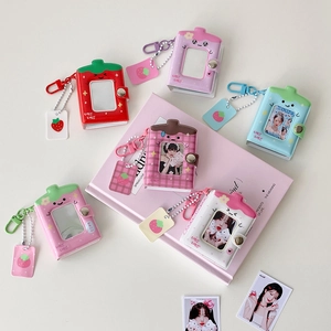 Close-up of mini strawberry photo albums in various colors with secure snap buttons