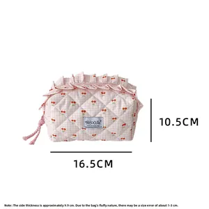 Detailed view of pink checkered makeup bag with cherry print and 16.5cm length dimensions