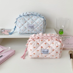 Detail of quilted cherry embroidery and ruffle edge on cute canvas cosmetic bags