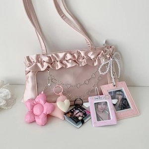 Detail of pink satin ruffle bag with clear PVC window and heart flower charms