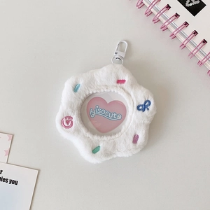 Close-up of white plush flower bag for 58mm anime badges with clear window and hook