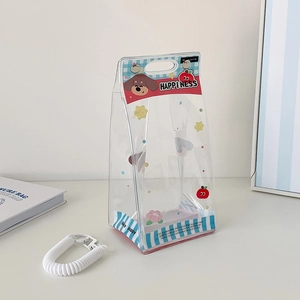 Close-up of transparent PVC doll carrier bag with cute dog print and spring keychain