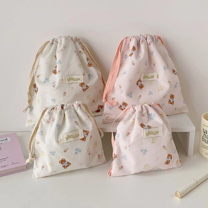 Cute bear drawstring storage bags in cream and pink colors for travel organization