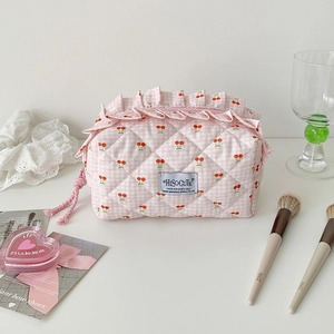 Detail of cherry checkered storage bag with quilted fabric and cute ruffle edge finish