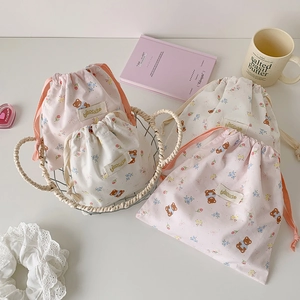 Detail of cute bear drawstring storage bags in pink and beige with bisocute label