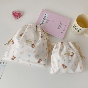 Close-up of cute bear and rabbit printed cotton drawstring storage bags for travel