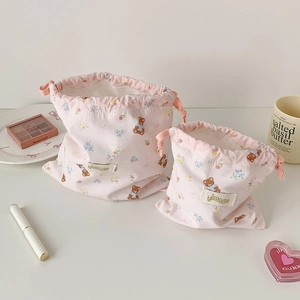 Set of two pink drawstring pouches with cute bear and floral prints for cosmetics