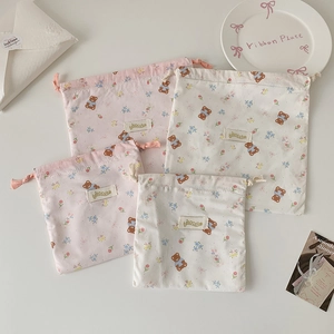 Cartoon bear drawstring organizer pouches in pink and white cotton with floral patterns
