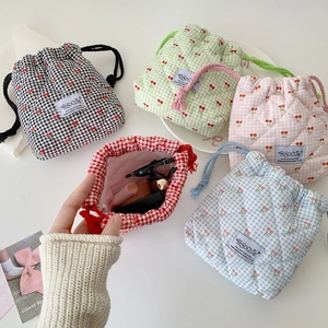 Quilted cherry drawstring pouches in five colors for organizing small makeup items