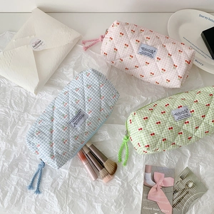 Quilted cherry print cotton cosmetic pouches in pink, light blue, and green for makeup storage