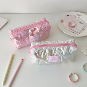 Detail of star-quilted laser pencil cases in holographic pink and silver finishes