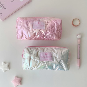 Close-up of star-quilted holographic fabric on stylish portable stationery bags