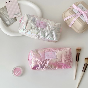 Macro shot of iridescent pencil cases with star quilting and pink label details