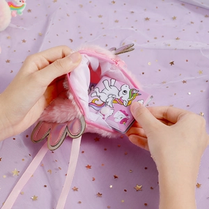 Pink plush unicorn shoulder bag with shiny wings and zipper opening for kids