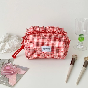 Close-up of red gingham cherry quilted pencil case with ruffle detail and zip closure