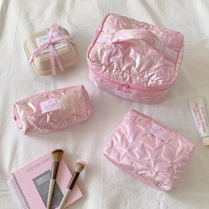Pink star-quilted cosmetic bag set including a handbag, clutch, and pencil case