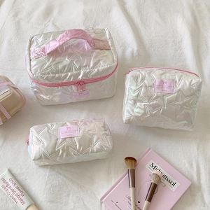 Three-piece quilted star makeup bag set in iridescent white with pink zipper details